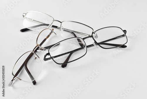 Glasses on a white background. Rectangular glasses in different frames. Three pairs of glasses.
