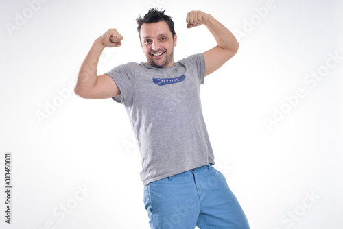 Young man wearing a t-shirt, smiling isolated on white 