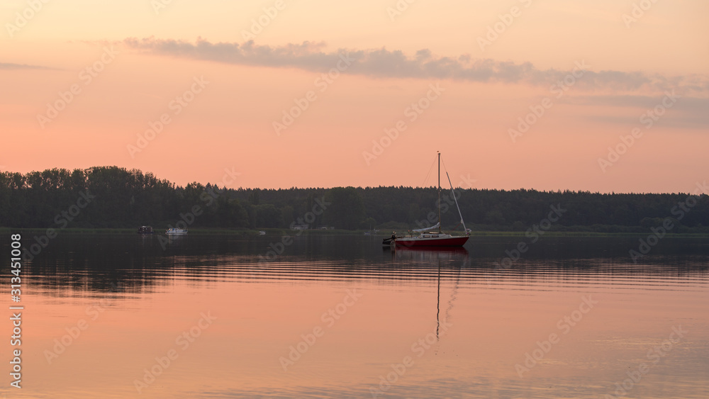 Sailing boat at sea during sunrise