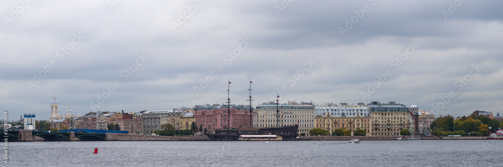 Panoramic view of St. Petersburg, Russia by Neva River against dramatic cloudy sky