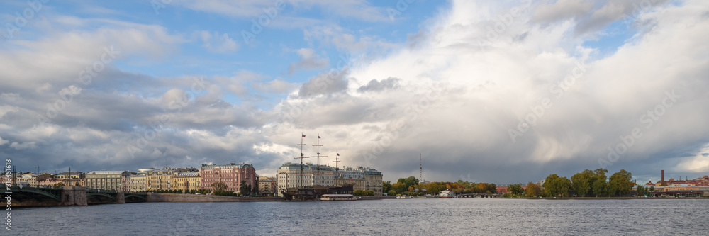 Panoramic view of St. Petersburg, Russia by Neva River against dramatic cloudy sky