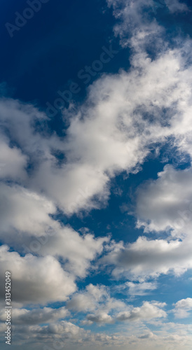 Fantastic clouds against blue sky, panorama