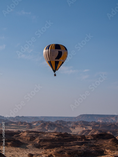 Winter at Tantora Hot Air Balloon Festival over Mada'in Saleh (Hegra) ancient site, Al Ula, Saudi Arabia © hyserb