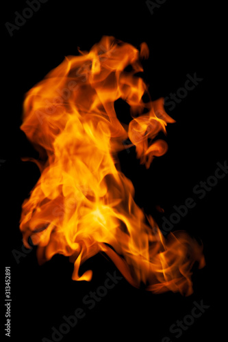 Fire and burning flame isolated on dark background for graphic design purpose © Akarawut
