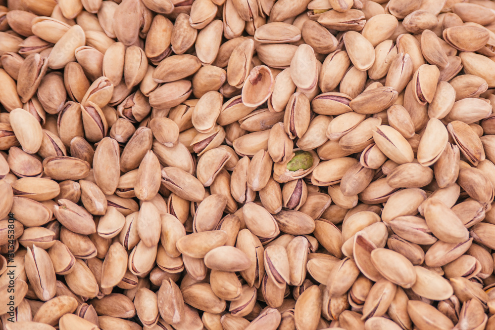 Beautiful selected organic pistachios in shell background, lots of pistachios in shell on a market counter. Beautiful selected organic pistachios in shell background, lots of pistachios in shell on a market counter.