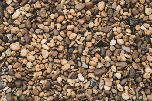 Textured small brown stones background.
