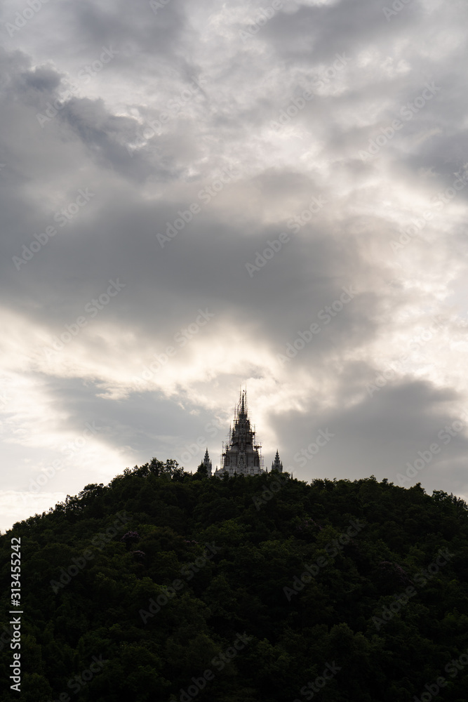 Silhouette pagoda at mountain against dark sky