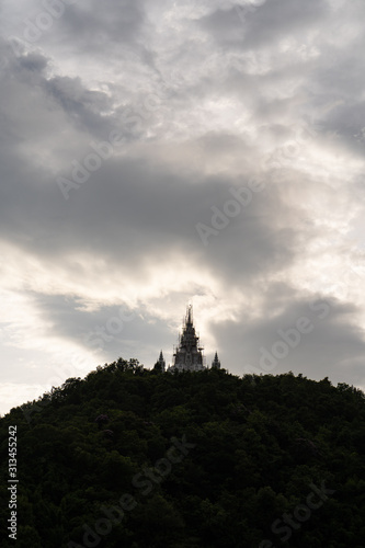 Silhouette pagoda at mountain against dark sky © tienuskin