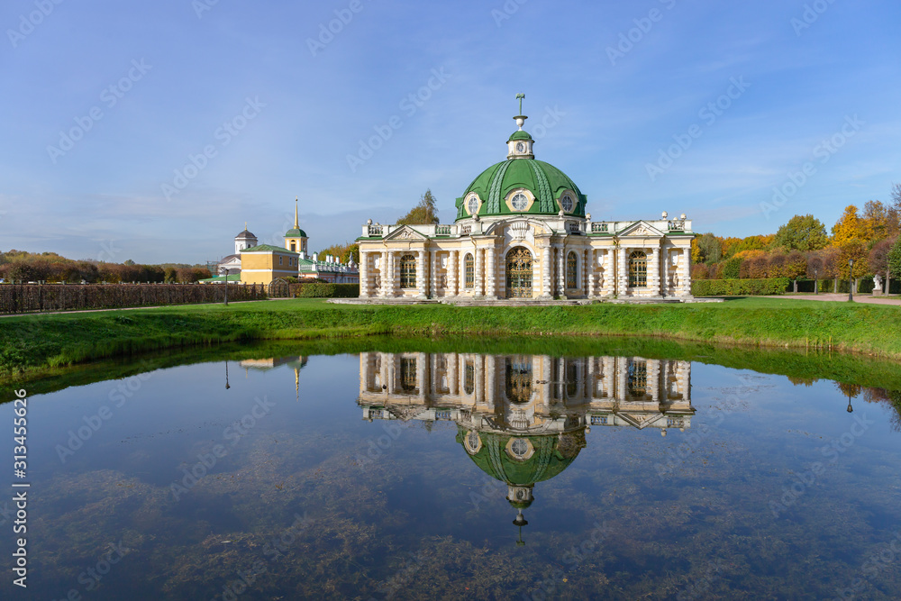 The picturesque pavilion is located on the Bank of a pond in the Park. Autumn day is Sunny. Kuskovo, Moscow, Russia.