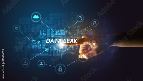 Hand touching DATA LEAK inscription, Cybersecurity concept