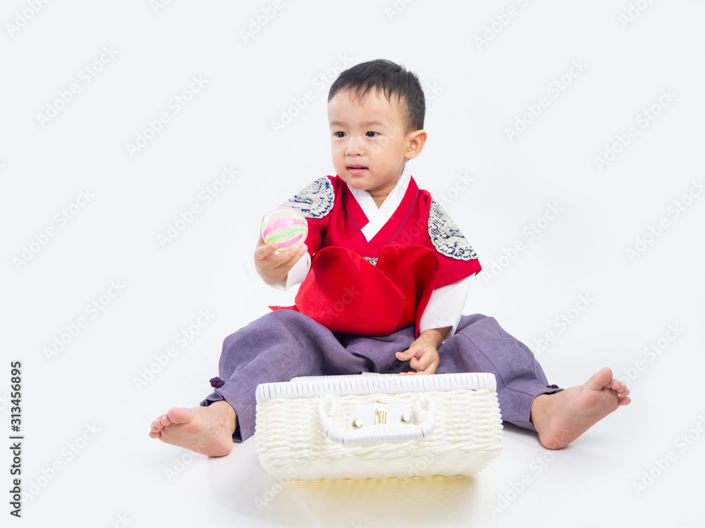 Asian little boy and girl wearing a Korean Traditional Hanbok dress in Rattan bag on white background Asian little boy and girl wearing a Korean Traditional Hanbok dress in Rattan bag on white background