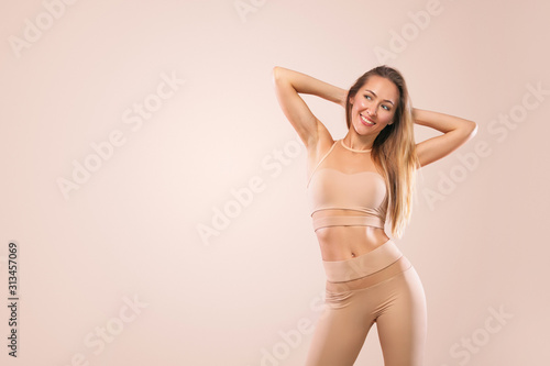 Indoor Yoga Classes. Sports recreation. Beautiful young woman in asana pose. Individual sports. Nude sportswear.