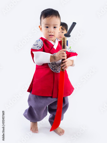 Asian little boy and girl wearing a Korean Traditional Hanbok dress in Rattan bag on white background