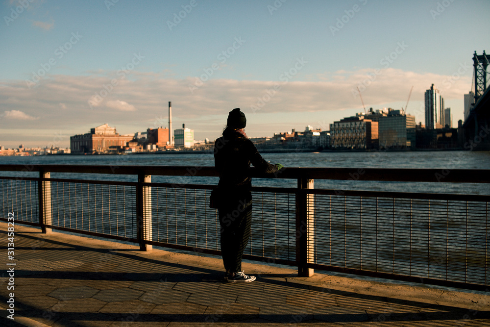 Fototapeta premium Young Woman Looking over the Hudson River in New York City