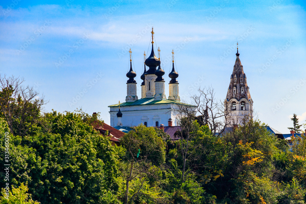 View of the Ascension Church with a bell tower of St. Alexander monastery, located on the left bank of the Kamenka river in Suzdal, Russia. Golden Ring of Russia