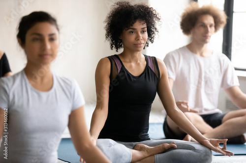 African American woman practicing yoga, doing Padmasana exercise