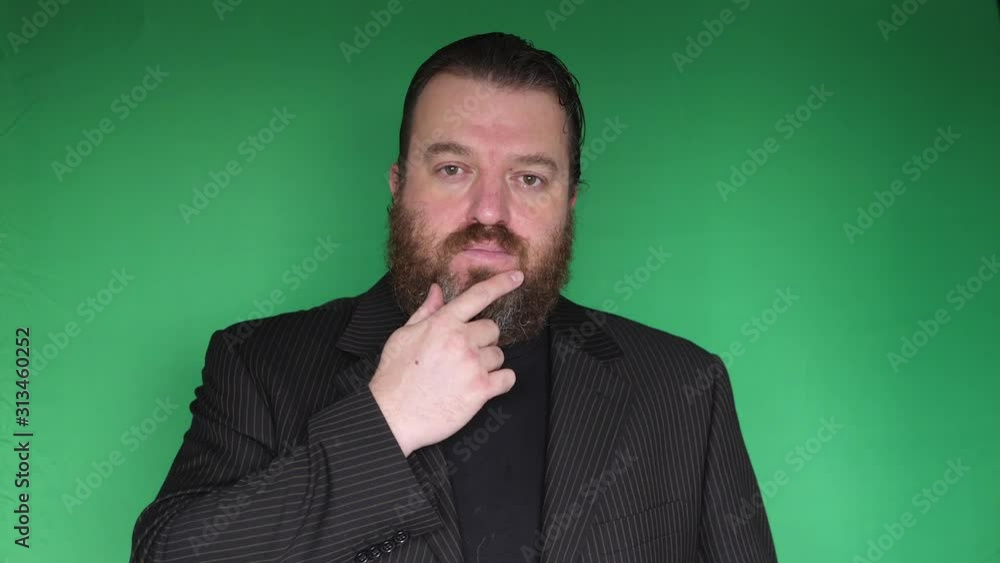 Bearded businessman is looking for something on the tablet Bearded businessman is looking for something on the tablet