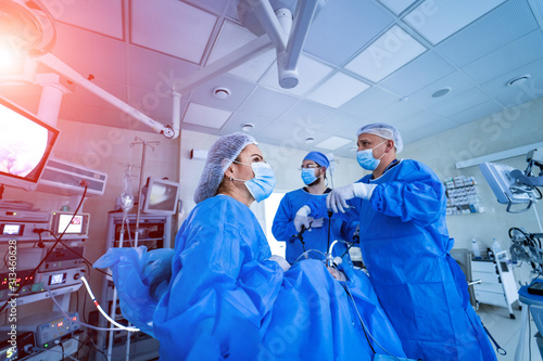 Medical team performing an operation in a surgery room of clinic. Doctors concept.