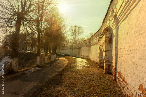 View of the street located near the walls of the ancient Kremlin. There is a Sunny day in early spring. Vladimir, Russia.