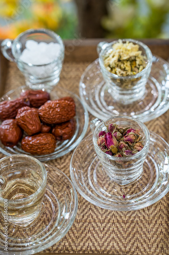 Spices in grass on wooden tray. 