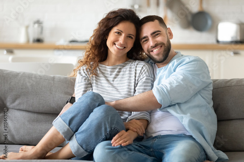 Portrait of couple posing photo shooting seated on couch indoors photo