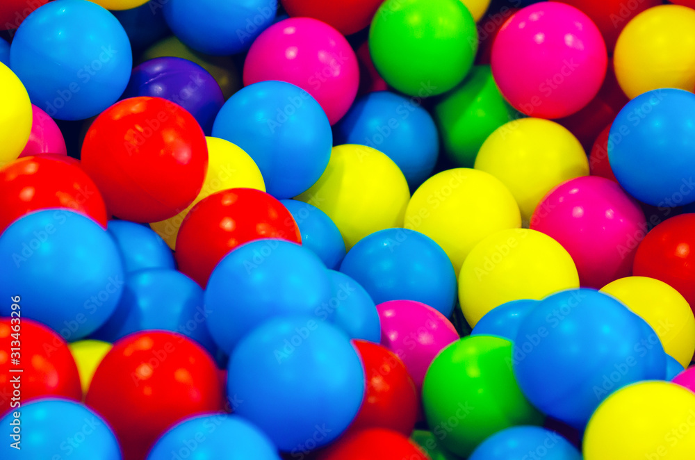 Small multi colored plastic baby balls, background texture Small multi colored plastic baby balls, background texture