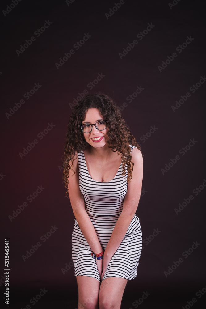 Young girl model posing with cute dress in black background Young girl model posing with cute dress in black background