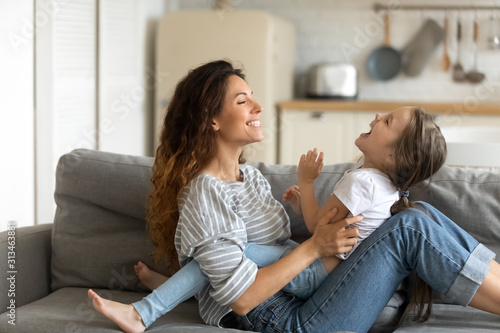 Mother playing with little daughter enjoy time together on weekend