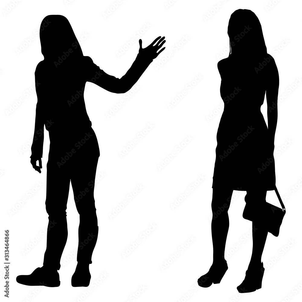 Two vector silhouettes of young girls standing. Girl in a dress with a handbag and a girl in jeans with outstretched hand, palm indicates the direction isolated on white background.