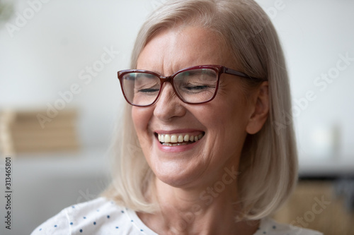 Close up of happy mature woman smiling showing teeth