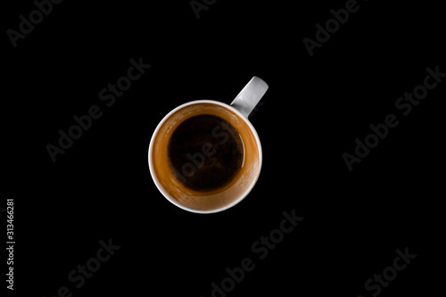 Cup of coffee over the black background