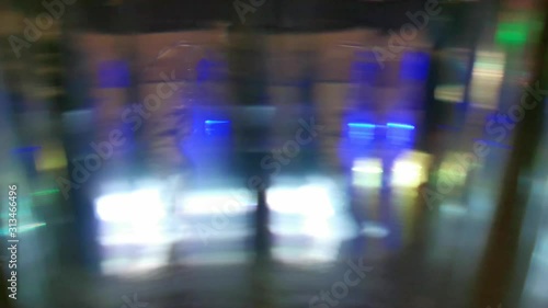 Dynamic blurred video. Flashing colored lights, neon behind the glass. Motion video. Colorful garlands. Blurred view. Bright illuminated scene. Abstract background, backdrop for any purpose