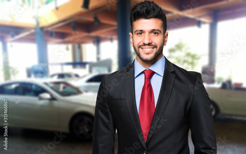Car dealer smiling in a car saloon © Minerva Studio