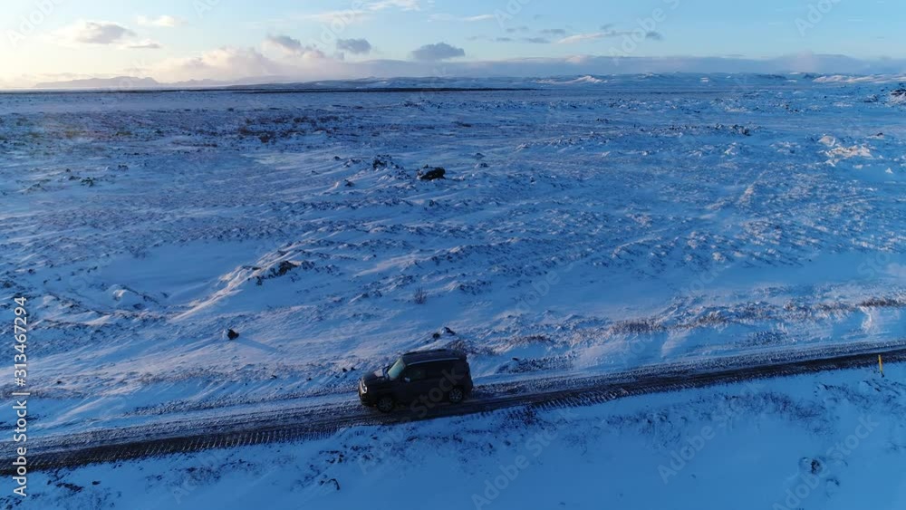 Car 4x4 driving along in Iceland landscape during winter Car 4x4 driving along in Iceland landscape during winter