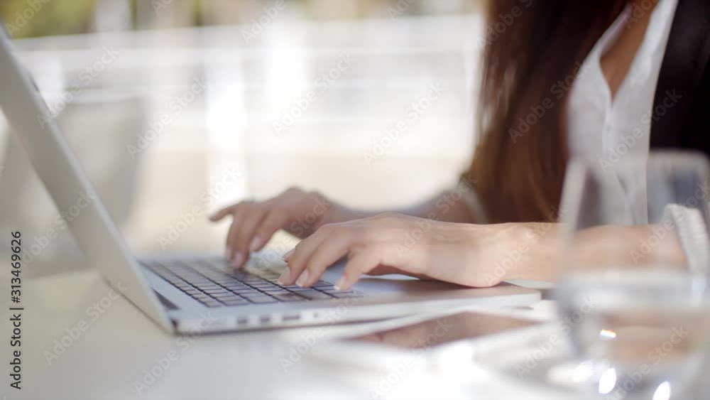 businesswoman typing on a laptop computer businesswoman typing on a laptop computer