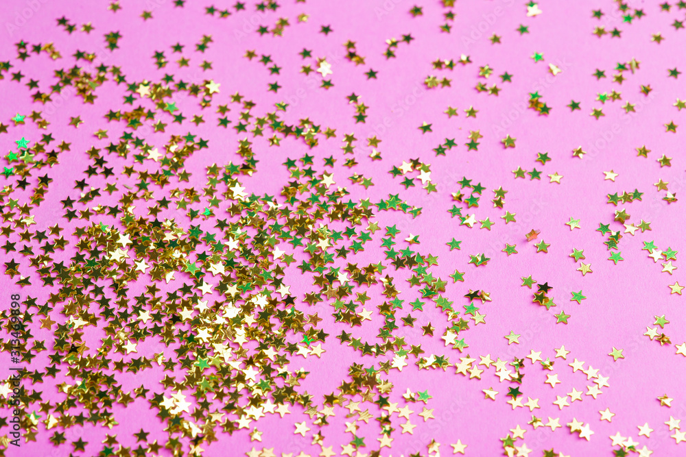 Glitter on a pink background. Celebration, party, birthday magic background. Creative minimal art concept Glitter on a pink background. Celebration, party, birthday magic background. Creative minimal art concept