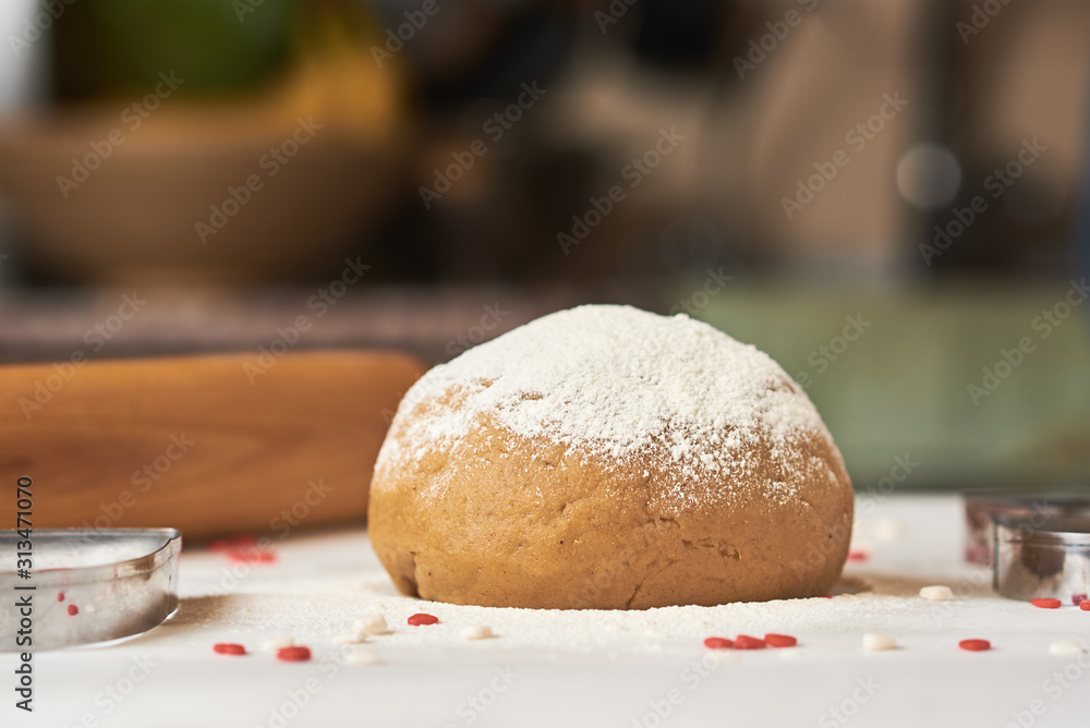 ball of raw dough sprinkled with flour on the table ball of raw dough sprinkled with flour on the table