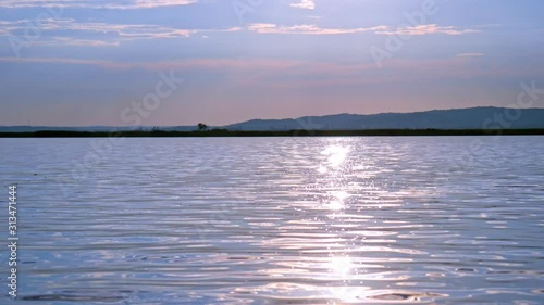 View on the sunset over the Velence lake with the sun reflecting on the water surface in Hungary. photo