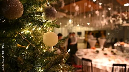 Christmas tree with decorations and a garland at the reception in a premium restaurant