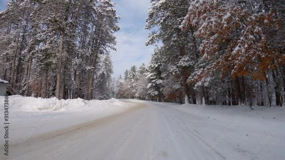 Driving a car along winter snowy road surrounded by trees with fresh snow. Hyperlapse POV front car view. Blue sky with clouds. Beautiful winter scenery Driving a car along winter snowy road surrounded by trees with fresh snow. Hyperlapse POV front car view. Blue sky with clouds. Beautiful winter scenery