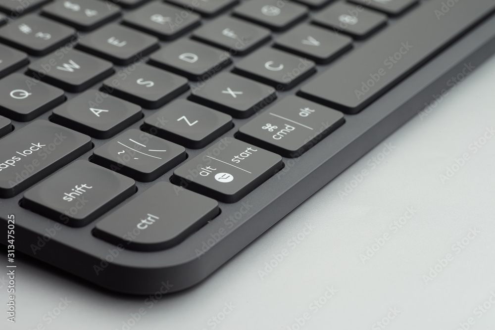 Close-up black keyboard keys on grey table Close-up black keyboard keys on grey table