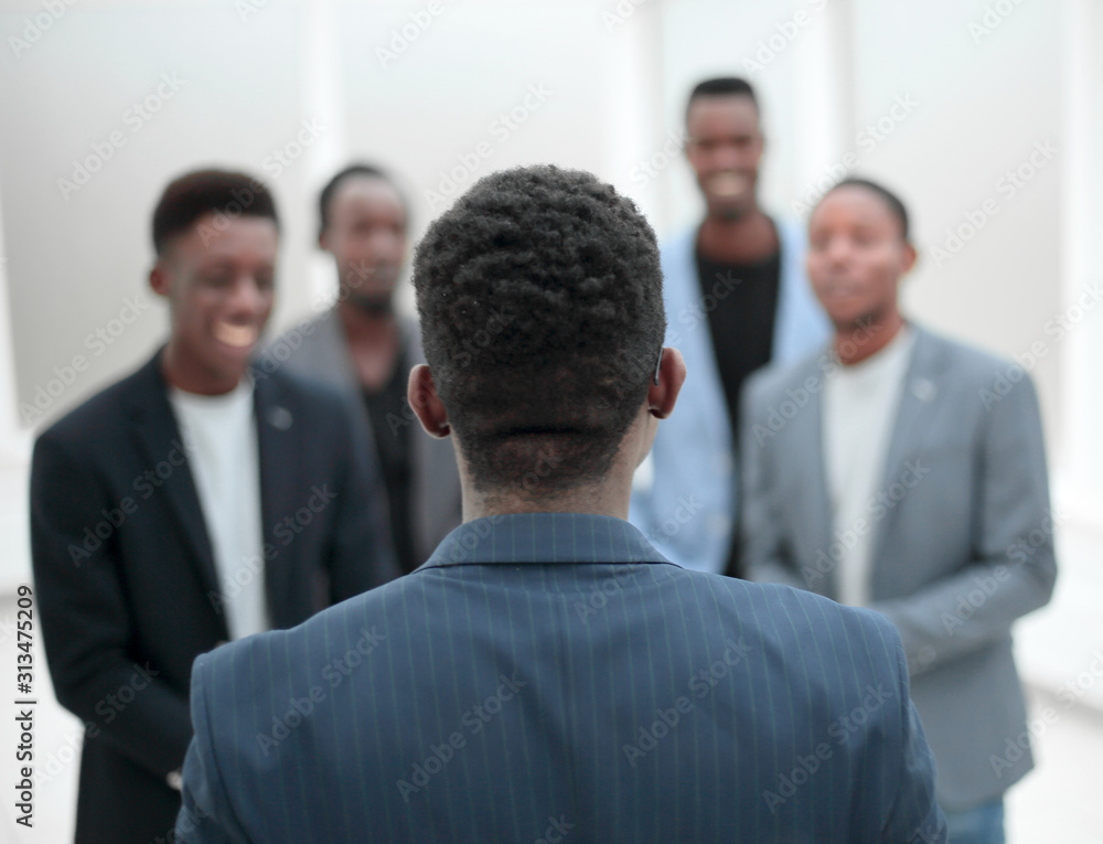 young businessman standing in front of his business team young businessman standing in front of his business team