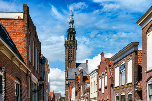 Cityscape with Church of Our Dear Lady in Edam. Although most of the church was demolished in 1882, the 15th-century tower and carillon remain standing today. photo