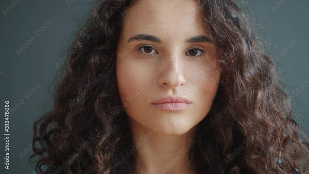 Close-up portrait of gorgeous mixed race girl with brown eyes and curly hair looking at camera with serious face. Independent girls, youth and emotions concept. Close-up portrait of gorgeous mixed race girl with brown eyes and curly hair looking at camera with serious face. Independent girls, youth and emotions concept.
