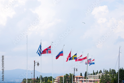 Port on Lake Garda. Flags of European countries. Summer landscape. Cisano, Italy. Europe. photo