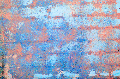 Old concrete wall. Peeling plaster on wall of house, building or fence surface. Toning in bright neon pink and blue colors. Modern urban backdrop. Copy space. Place for text. Selective focus image.