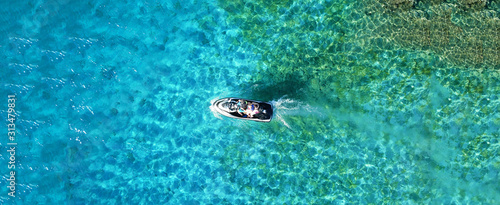 Aerial drone ultra wide photo of jet ski watercraft docked in tropical exotic lake