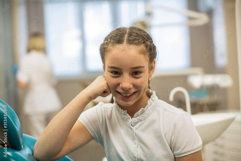 Portrait of schoolgirl with the sceptical look in the dental office. Portrait of schoolgirl with the sceptical look in the dental office.