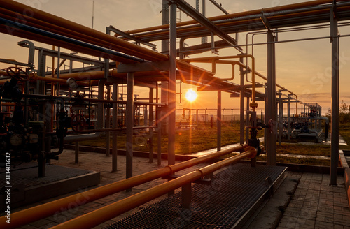 Gas industry. Pipeline system at gas processing plant illuminated by the rays of the rising sun © Sergey