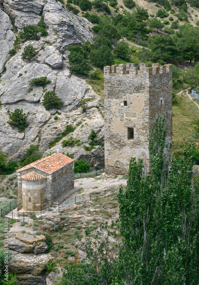 Ancient tower and church near fortress in Sudak, Crimea, Russia.